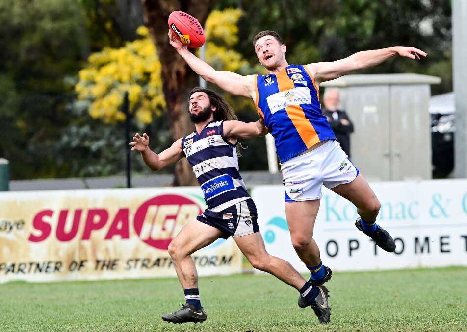 AGILE: Golden Square defender Will Lee tries to take a one-handed mark in front of Storm forward Jye Formosa. Picture: BRENDAN McCARTHY