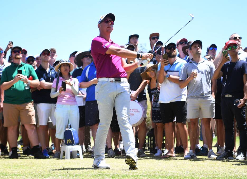 Lucas Herbert watches his approach shot on the fifth hole at The Australian Golf Club.