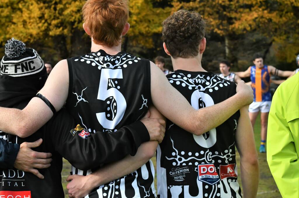 Ashton Keogh, right, with team-mate Brodie Byrne during the minute silence. Picture by Adam Bourke