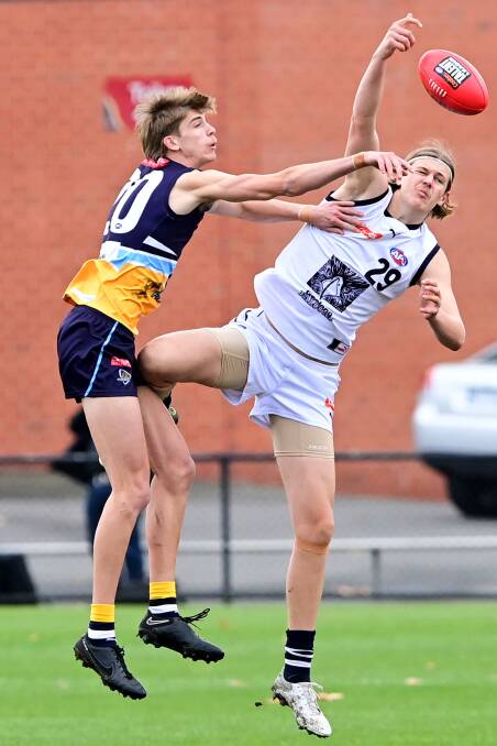 Jacob Nihill punches the ball clear of his Geelong opponent. Picture by Brendan McCarthy