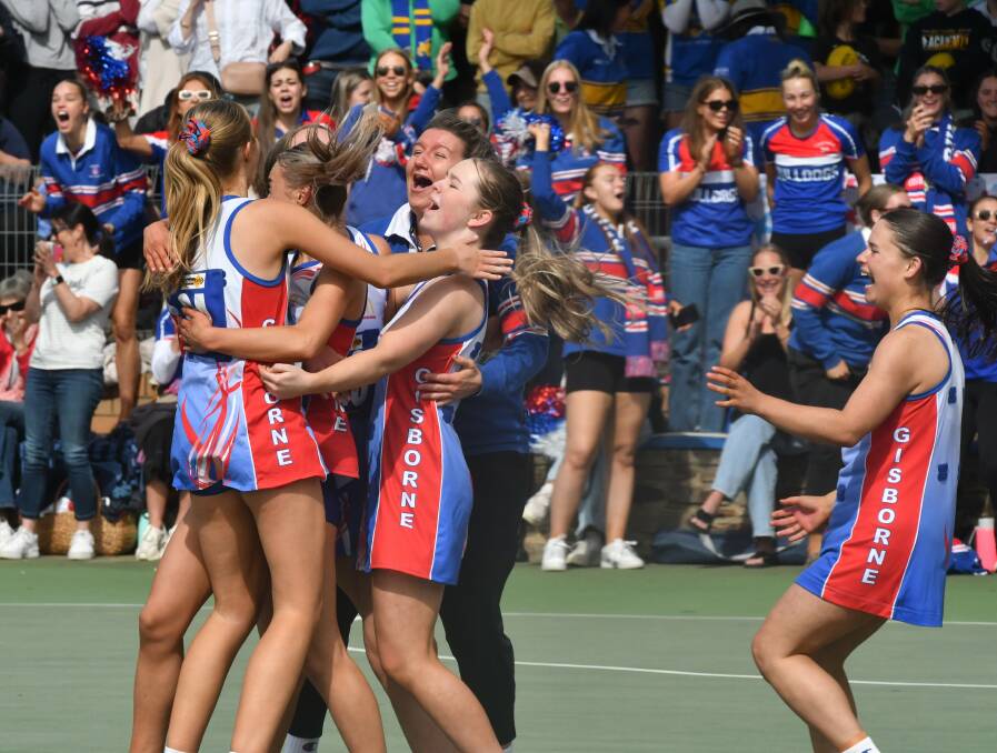 Gisborne 17-and-under netballers after the final whistle in the Bulldogs' grand final win over Sandhurst. Picture by Adam Bourke
