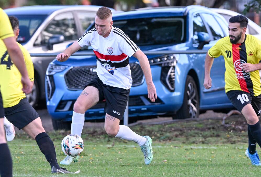 Golden City midfielder Timon Dooley looks for a team-mate against Shepparton. Pictures by Darren Howe
