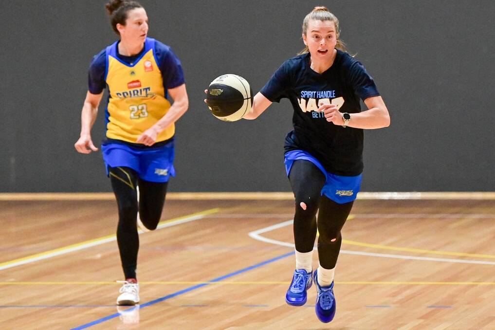 Abbey Wehrung leads Kelsey Griffin at Bendigo Spirit training as the club tries to break its duck this WNBL season. Picture by Brendan McCarthy