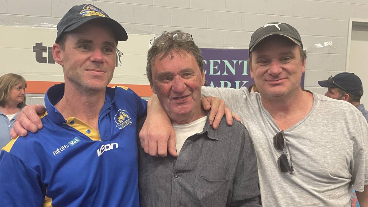 Golden Square coach Christian Carter celebrates BFNL premiership success with his father, Dick, and brother, Nick.