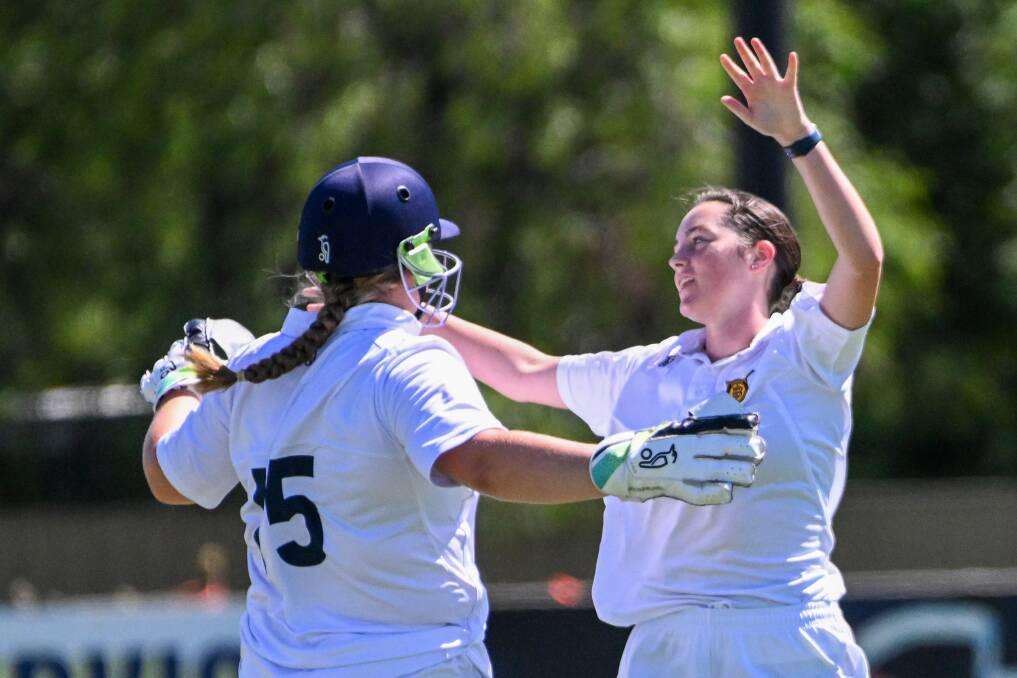 Bendigo's Natalie Flood and Bella Eddy celebrate a wicket against Gisborne. Picture by Darren Howe