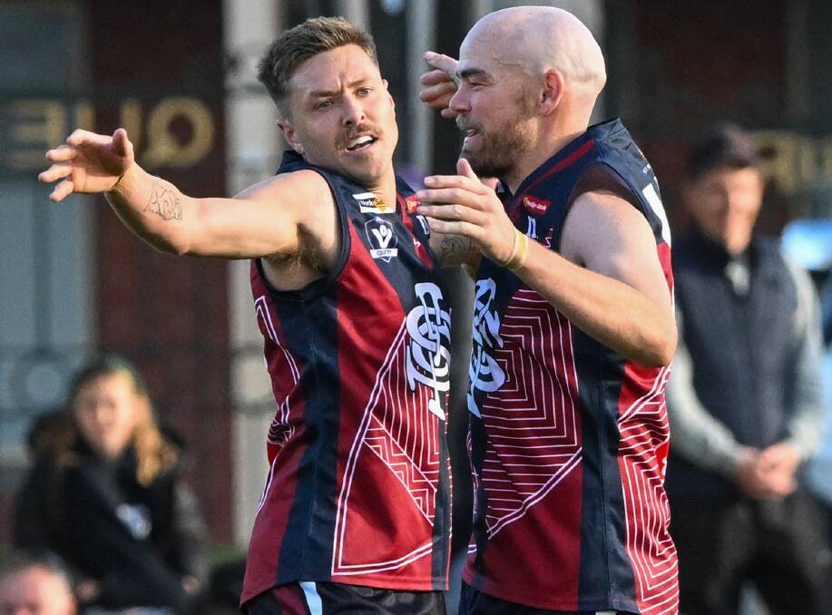 Sandhurst forwards Ferg Greene and Bryce Curnow celebrate a goal in the Dragons' 72-point win over Eaglehawk at the QEO. Picture by Darren Howe