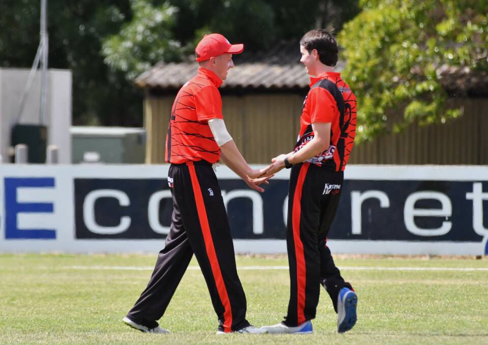 Sporties Spitfires skipper Liam Smith congratulates James Barri after he took a wicket. Picture by Adam Bourke