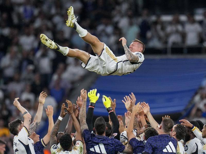 Club great Toni Kroos is tossed by Real Madrid teammates after his final Spanish league game. (AP PHOTO)
