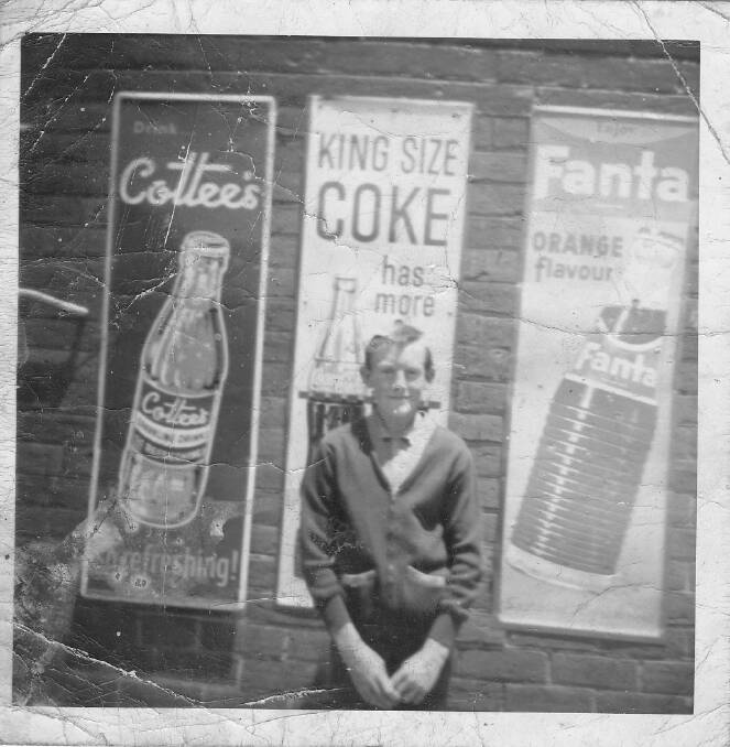 Barry Rohde in front of Coke sign around 1966