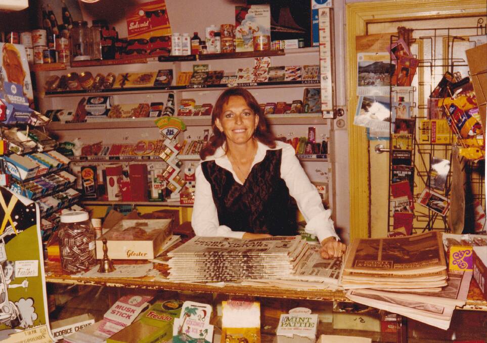 Barbara Zysvelt behind shop counter in 1977.