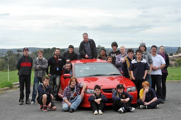 WORKING TOGETHER: Castlemaine Secondary College students and teachers taking part in the Elevate Dragcar automotive program with the ute they will work on this year.
